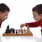 Two little boys playing chess